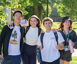 Group of students standing side by side outside. Links to Donor-Advised Funds