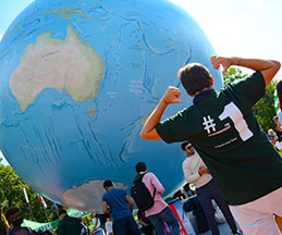 Photo of students around a globe sculpture. Link to Gifts That Protect Your Assets.